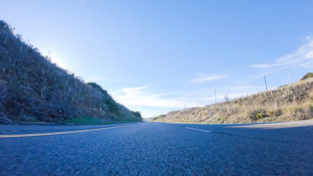 During the day, driving on HWY 101 near Arroyo Quemada Beach, California, offers scenic views of the surrounding coastal landscape.