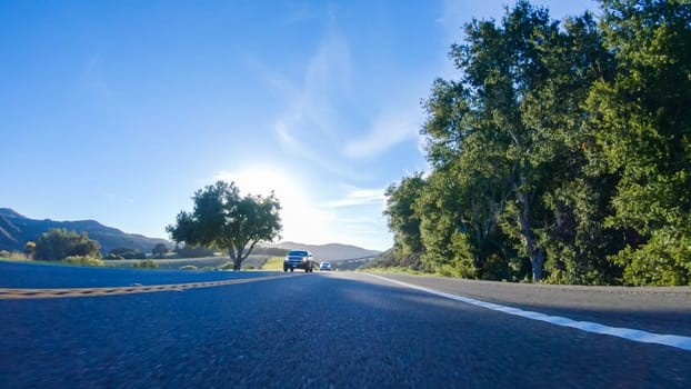 Basking in the beauty of a sunny winter day, driving on HWY 1 near Las Cruces, California offers stunning views of the picturesque coastal landscape against a backdrop of clear blue skies.