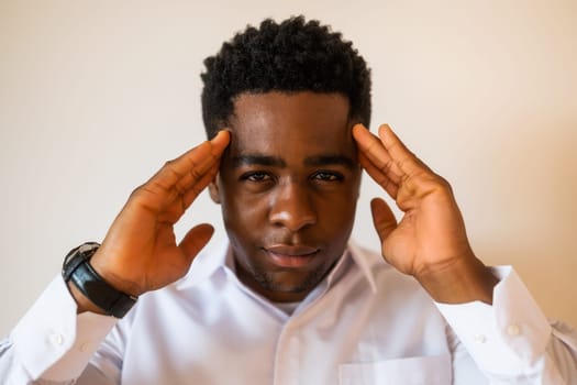 Portrait of young businessman who is trying to concentrate.