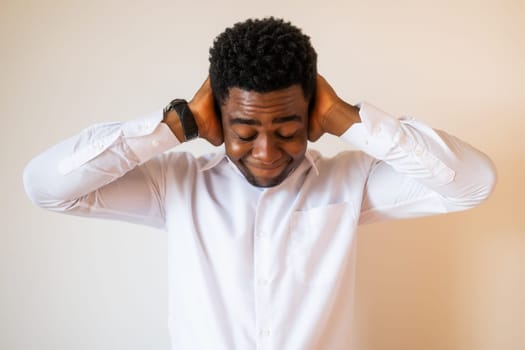 Portrait of young businessman who is tired and having headache.