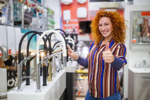 Portrait of salesperson in bathroom store. Happy redhead woman works in bath store. Sales occupation.