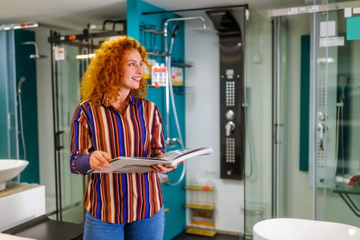 Portrait of buyer in bathroom store. Redhead woman is choosing equipment for her apartment.