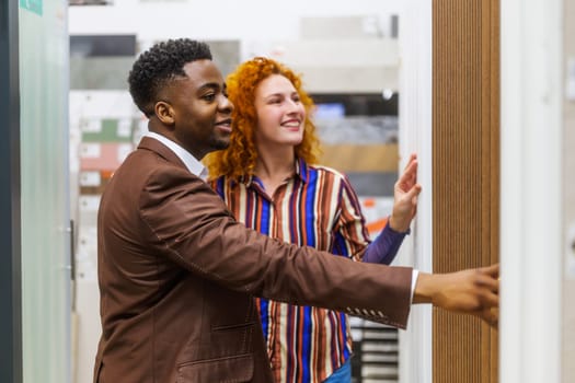 Happy couple choosing tiles for their apartment.