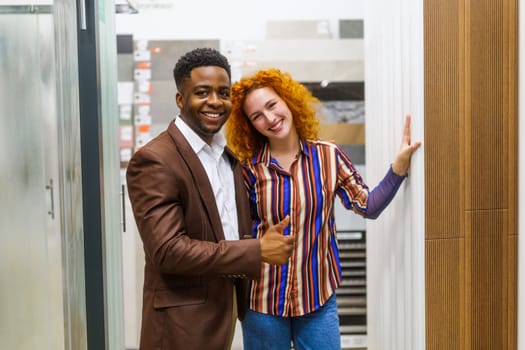 Portrait of young couple who owns small business bath store. Man and woman work in partnership.