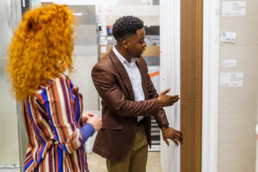 Happy couple choosing tiles for their apartment.