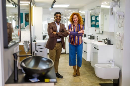 Portrait of young couple who owns small business bath store. Man and woman work in partnership.