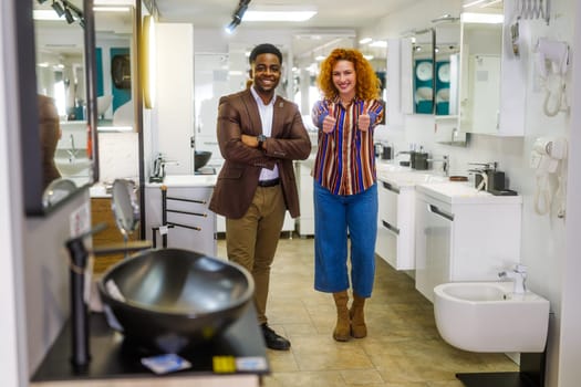 Portrait of young couple who owns small business bath store. Man and woman work in partnership.