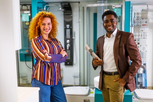 Portrait of young couple who owns small business bath store. Man and woman work in partnership.