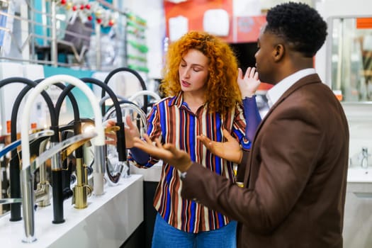 Couple choosing faucet for their apartment.