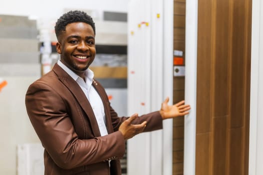 Portrait of salesperson in bathroom store. Happy man works in bath store. Sales occupation.