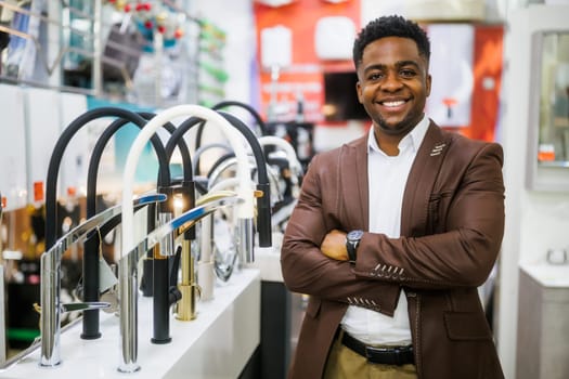 Portrait of salesperson in bathroom store. Happy man works in bath store. Sales occupation.