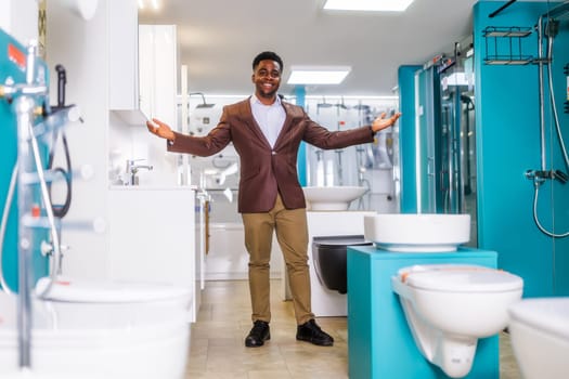 Portrait of salesperson in bathroom store. Happy man works in bath store. Sales occupation.