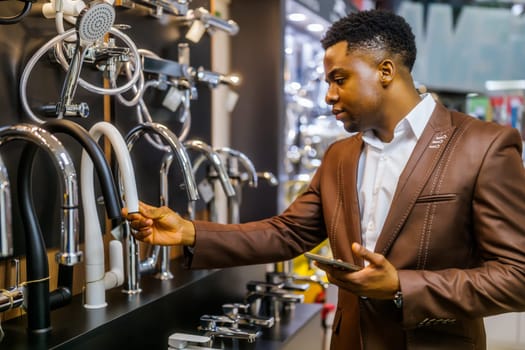 Portrait of buyer in bathroom store. Man is choosing faucet for his apartment.