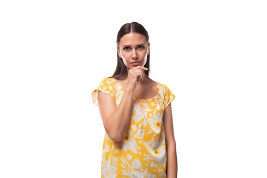 european surprised brunette lady with loose hair wearing a yellow t-shirt with a flower print.