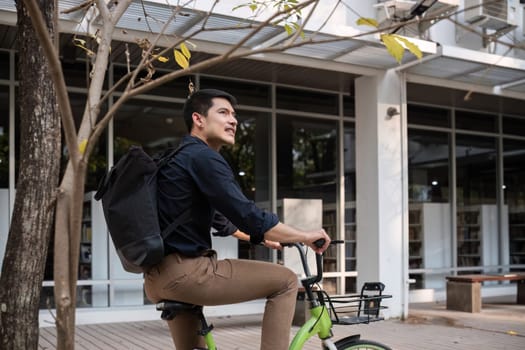 Young Asian businessman Go to work by cycling to reduce air pollution and stay healthy..