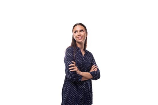 young well-groomed confident successful woman with black hair is dressed in a blue blouse.