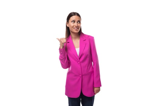 a young caucasian brunette business lady dressed in a bright raspberry jacket uses gestures in a conversation.