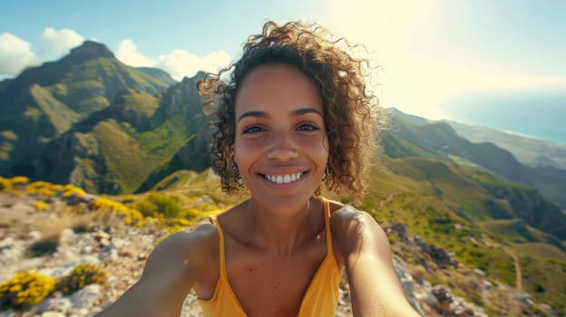 A woman smiling while taking a selfie on top of the mountain