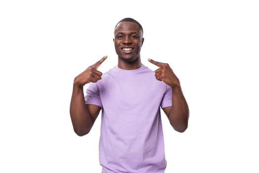 young african man of normal build dressed in a basic light lilac t-shirt with print mockup.
