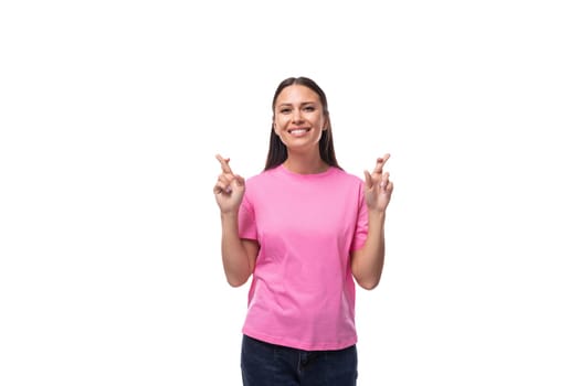 young stylish brunette lady dressed in a pink t-shirt feels optimistic.