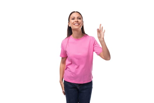 young positive happy slim woman dressed in a pink t-shirt. corporate clothing concept.