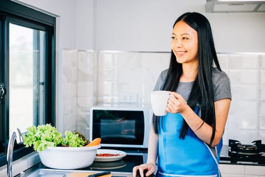 A woman enjoys her morning in a cozy kitchen holding a cup of coffee and smiling. Illustrating a carefree cheerful moment while savoring a hot drink at home.