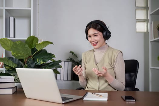 Asian female student studying online Video calls through Zoom about business administration and accounting subjects attentively.