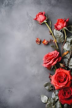 A group of red roses arranged on a grey background.