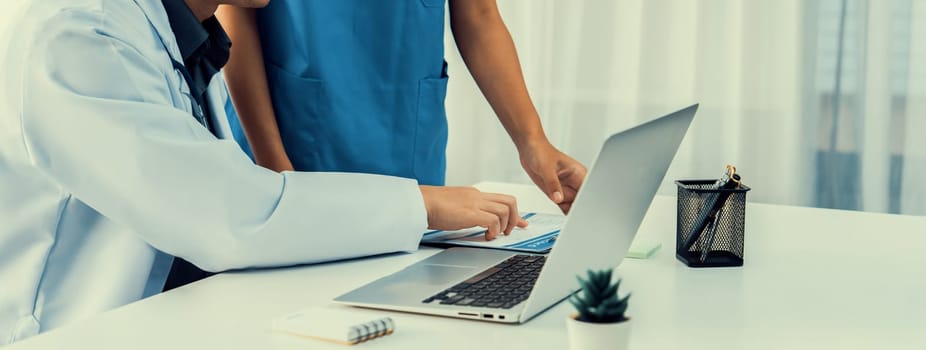 Professional various team of medical working and planning medical treatment at hospital table together. Teamwork lead to successful illness and sickness treatment. Panorama Rigid