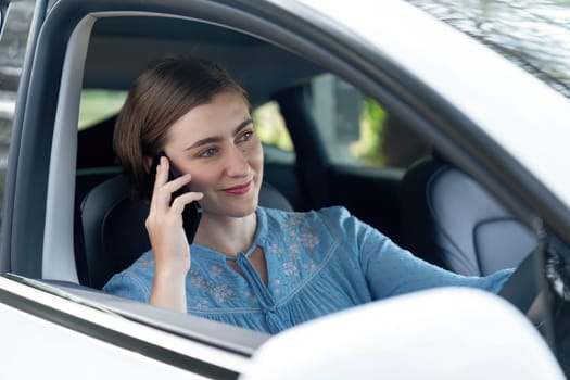 Beautiful woman in casual wear sitting on driver seat portrait. Cute girl driving a car concept with happy expression and pleasant smiling. Young woman with car road trip lifestyle. Perpetual