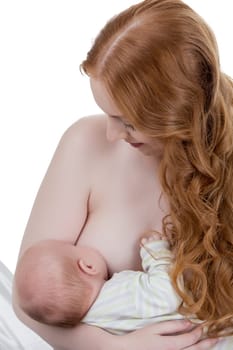 Image of beautiful red-haired mother nursing her child