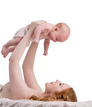 Attractive red-haired mother playing with her child