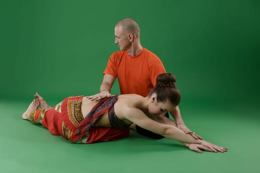 Yoga. Woman doing asana and instructor watching at her