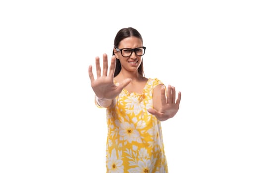attractive young woman with glasses for vision correction wearing an orange t-shirt says no.