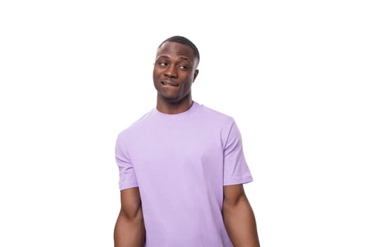 young charismatic 30 year old american man dressed in corporate lilac cotton t-shirt with print mockup.