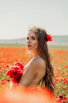 Woman poppies field. portrait of a happy woman with long hair in a poppy field and enjoying the beauty of nature in a warm summer day