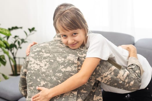 Little girl hugging her military father at home, closeup. High quality photo