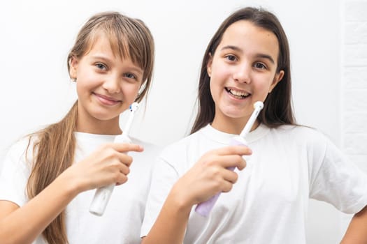 Funny portrait of a young girls brushing. High quality photo