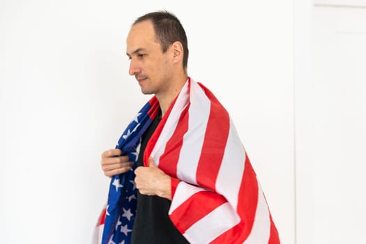 Caucasian businessman holding the flag of America isolated on white background. High quality photo