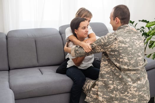 Soldier with his little children at home. High quality photo