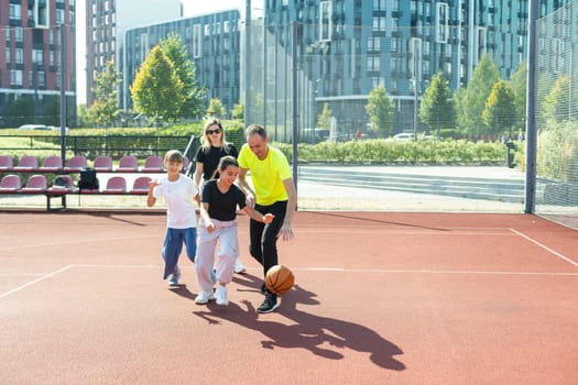 Caucasian family playing basketball together. Happy family spending free time together. High quality photo