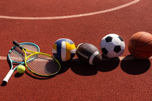 Set of sport equipment, rackets and tennis balls soccer and basketball balls.