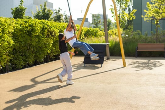 Caucasian little girls enjoying at outdoor children playground. Small girls playing at the park. High quality photo