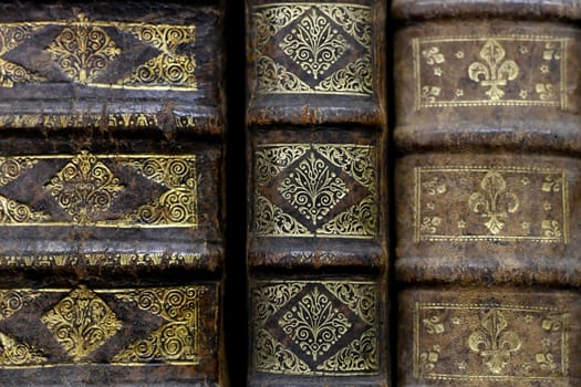 Old worn books on a shelf in the library's archives