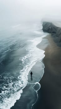 A person walking along the beach with a surfboard in hand