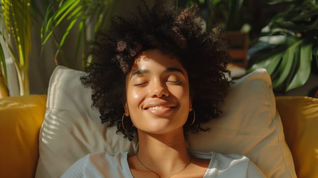 A woman with curly hair laying on a couch smiling