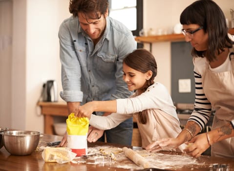 Mother, father and girl with flour for cooking in kitchen with dough, happiness and teaching with support. Family, parents and child with helping, learning and bonding with baking for cake or cookies.
