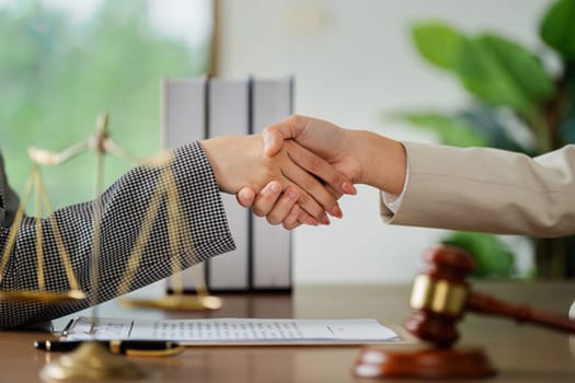 Lawyer handshake with a client making about documents, contracts, agreements, cooperation agreements
