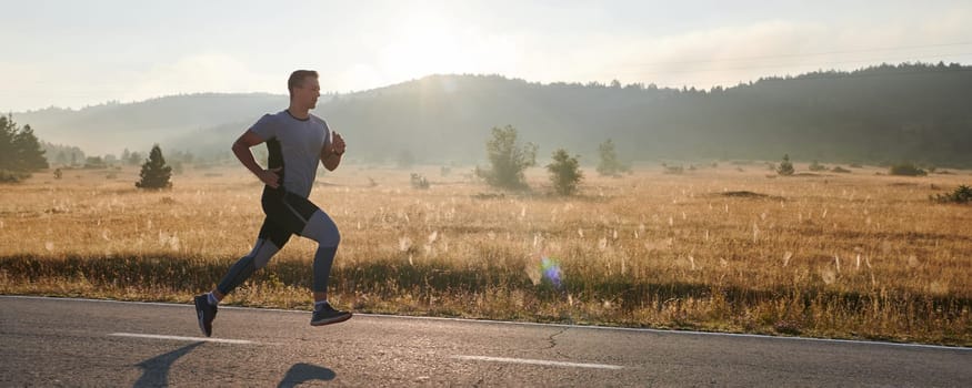 An athletic man exudes determination as he runs, embodying a commitment to a healthy lifestyle and preparation for an upcoming marathon competition