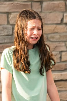 An unexpected dousing from a water mist leaves the little girl feeling a bit disheartened on a warm summer day.